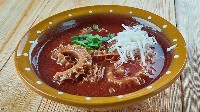 Mexican menudo served in a flat bowl