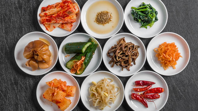 flatlay of different banchan or korean side dishes in small condiment dishes
