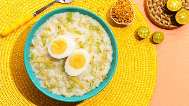 lugaw topped with sliced egg, toasted garlic, and green onion slices
