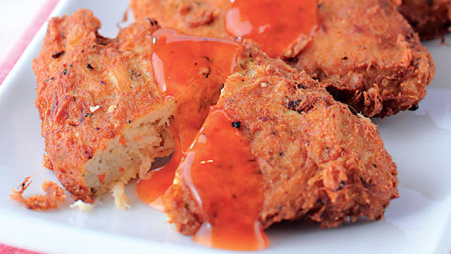 tortang alimasag or crab cakes with sweet and sour sauce drizzled on top