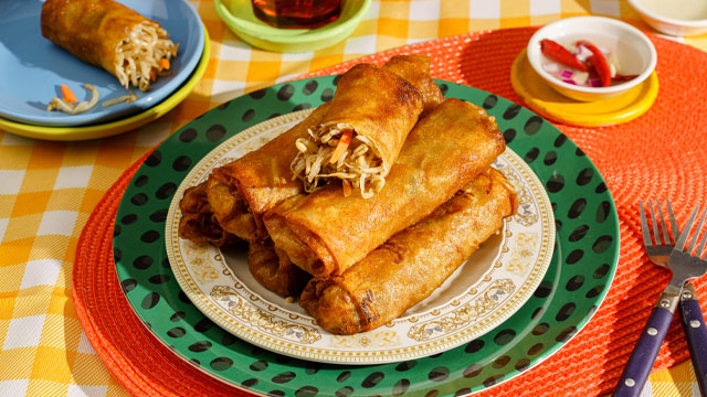 lumpiang togue piled on top of each other with the top one sliced open