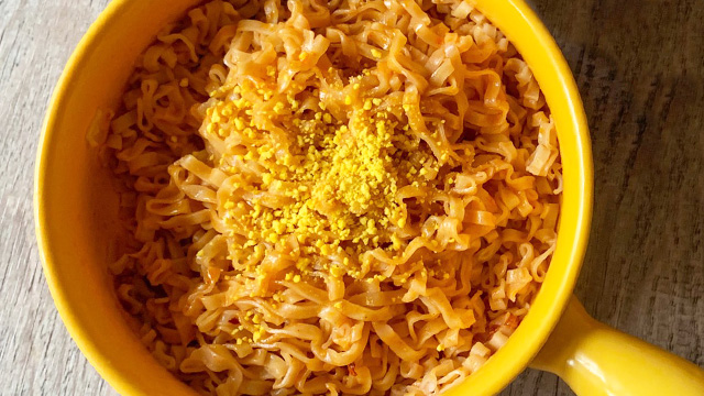 cooked bowl of nissin irvin's hot boom spicy salted egg instant noodles