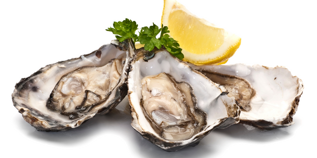 three oysters and a slice of lemon on a white background