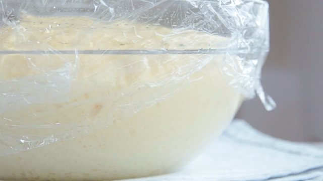 bread dough in a glass bowl set aside to let rise or proof
