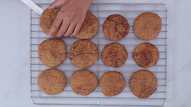 baked snickerdoodle cookies on a wire rack to cool after baking