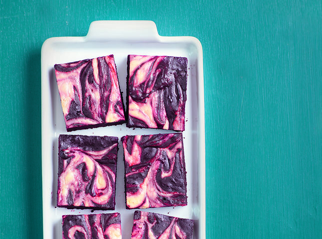 The stunning color of these brownies is courtesy of red food coloring and cream cheese.